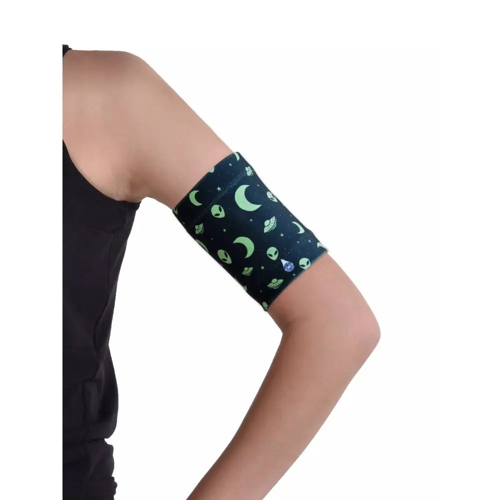 Blood glucose sensor armband for kids with fun moon and space pattern, fits securely and comfortably.