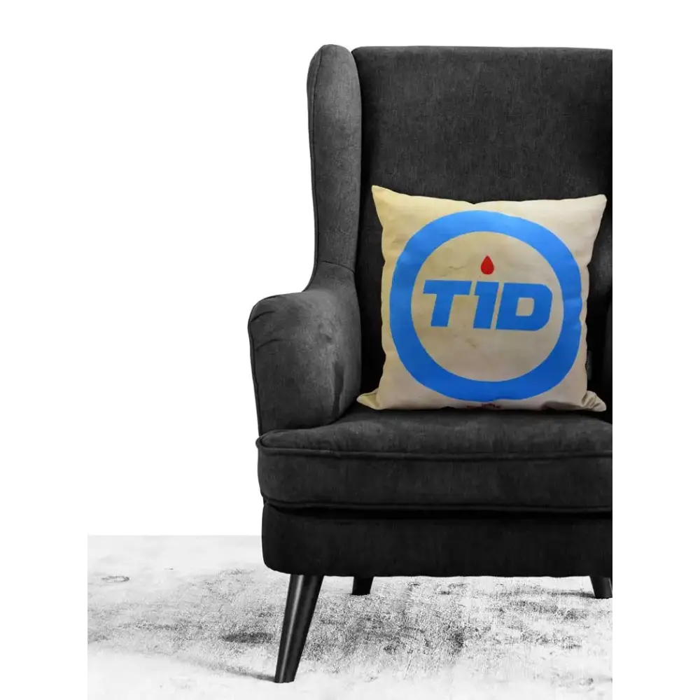 Diabetes Awareness Pillow Cover on dark armchair, blue circle design, supportive home decor.