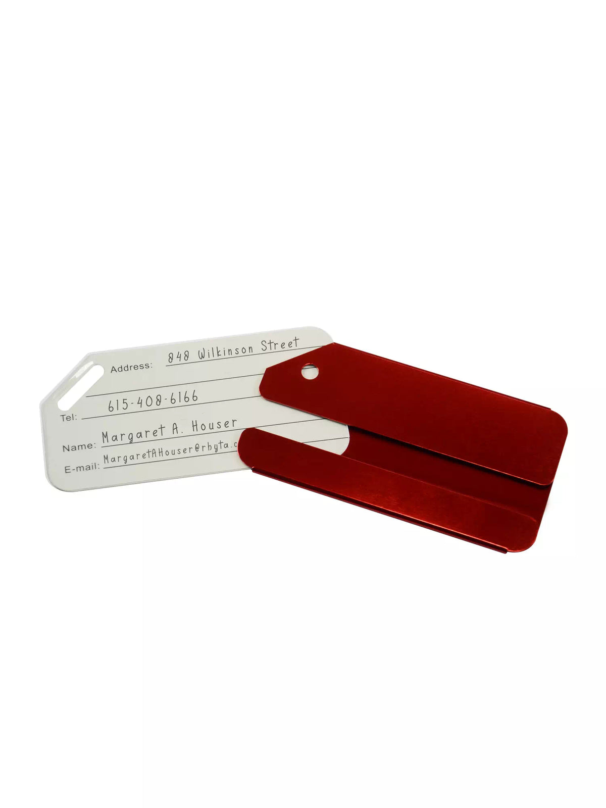 Red luggage tag opened to reveal personal information including address, phone number, and email.