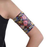Floral print Dia-Band blood glucose sensor armband on arm.