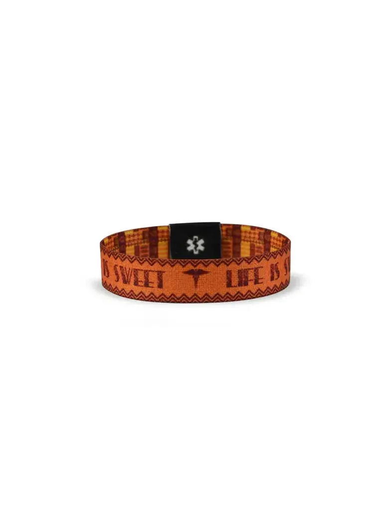 Reversible diabetes awareness wristband with orange and black design, featuring awareness messages.